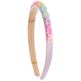 A pastel lavender headband decorated with a row of colorful pastel beads and small pink flower charms, shown on a plain white background.