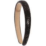 A black rhinestone-embellished headband with a tan suede-like inner lining, shown on a plain white background.