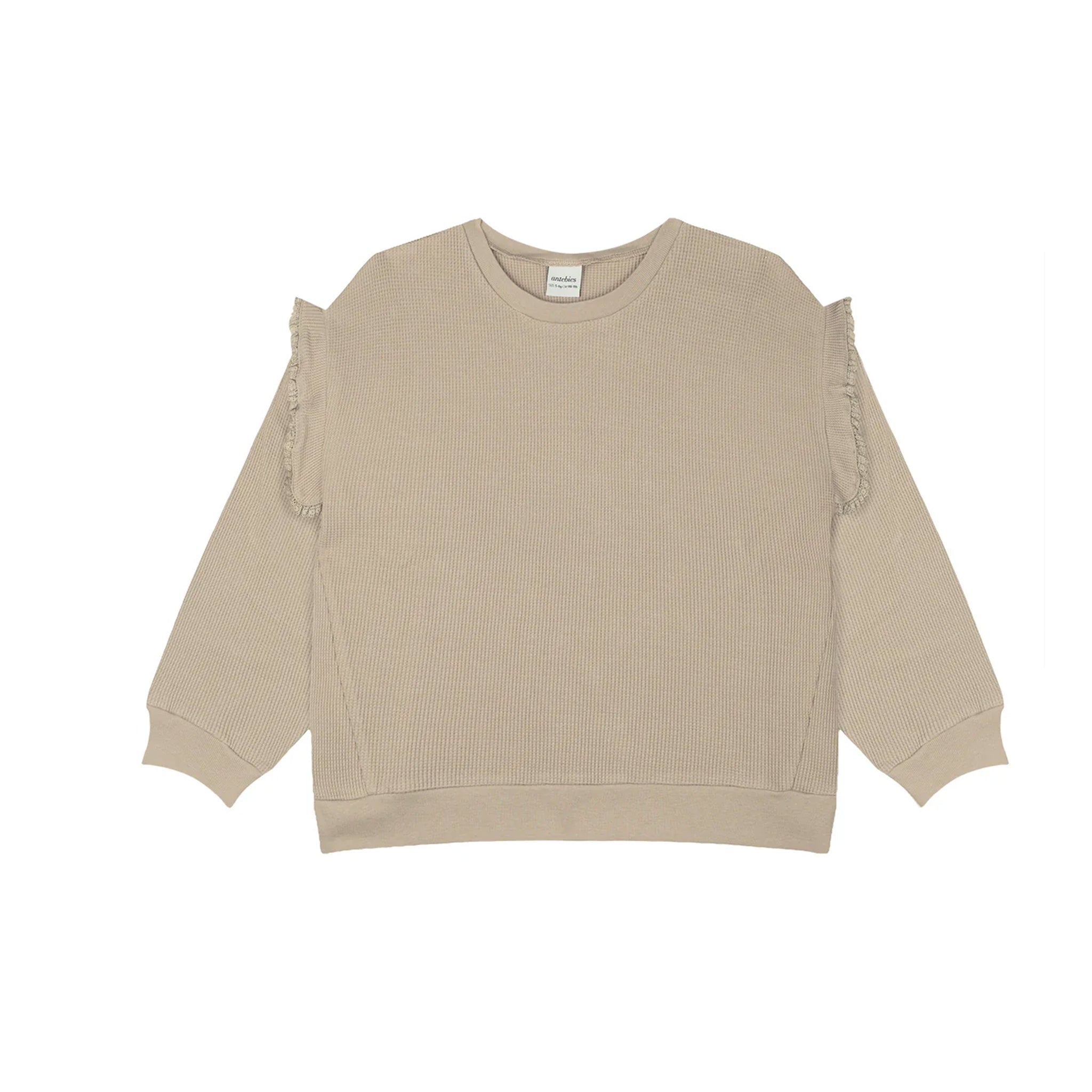 A beige ribbed knit long-sleeve sweatshirt with frayed ruffle details along the shoulders, displayed flat against a solid white background.