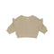 A beige ribbed knit long-sleeve crop top with ruffled shoulder details, shown flat on a white background.