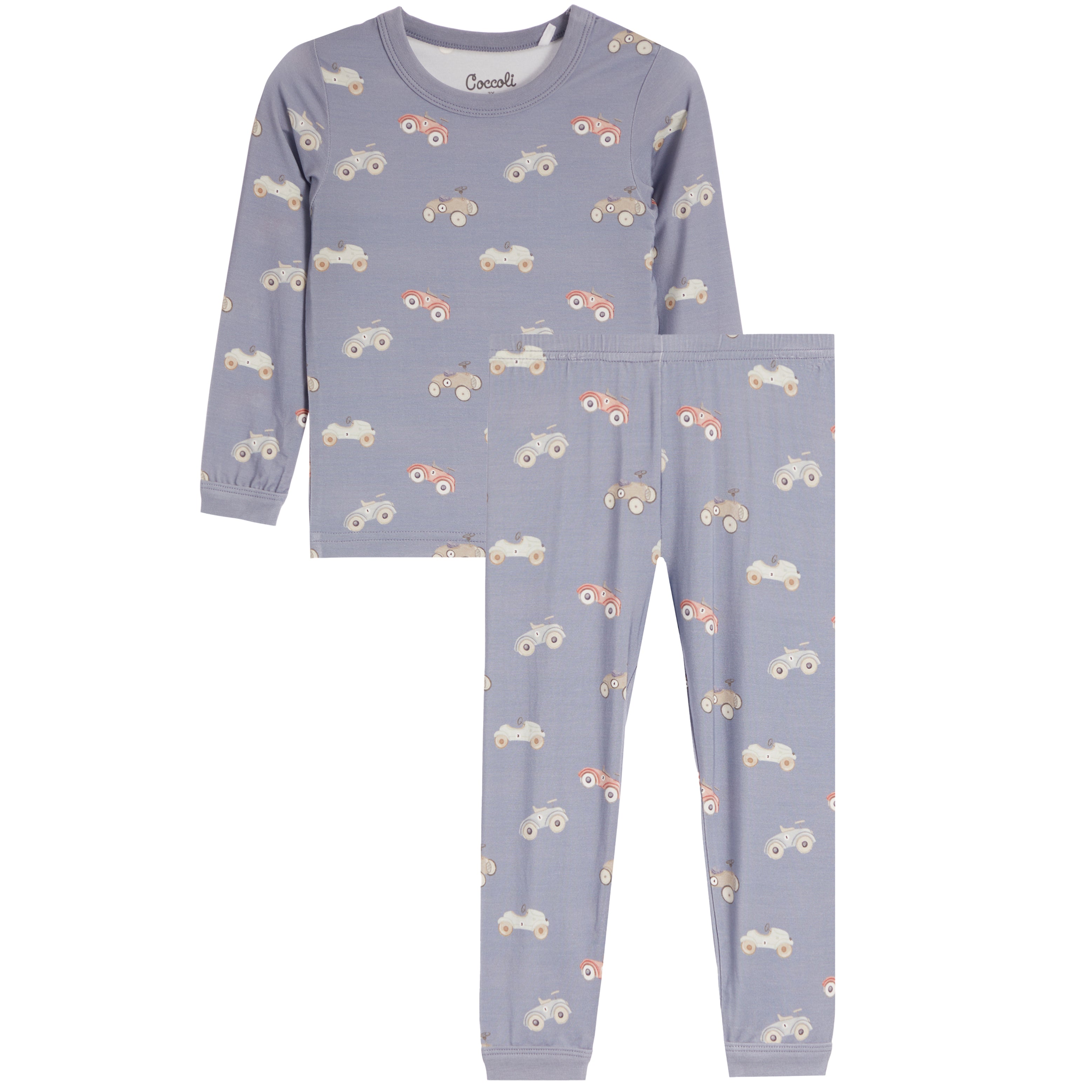 A two-piece children's pajama set featuring a long-sleeve top and matching pants in a dusty blue color, both printed with a repeating pattern of small tractors and cars in orange, white, and gray.  