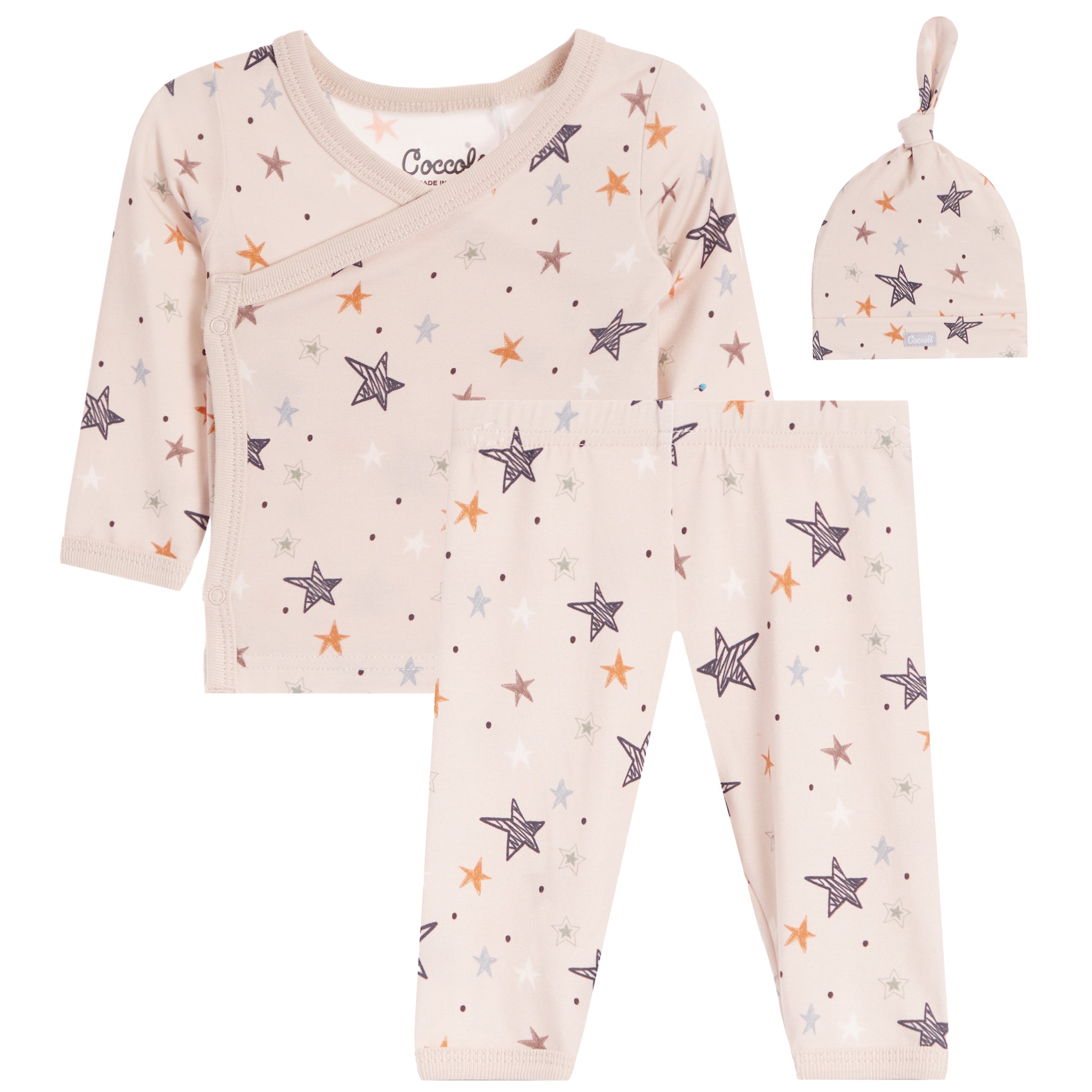 A three-piece baby clothing set including a long-sleeve wrap top, pants, and a knotted hat, all in a light beige color with an all-over star print in gray, white, and orange. 