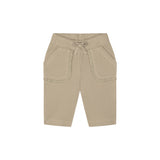 A pair of beige ribbed knit shorts for toddlers, featuring a drawstring waistband, side pockets with decorative ruffle trim, and a relaxed fit, shown against a plain white background.
