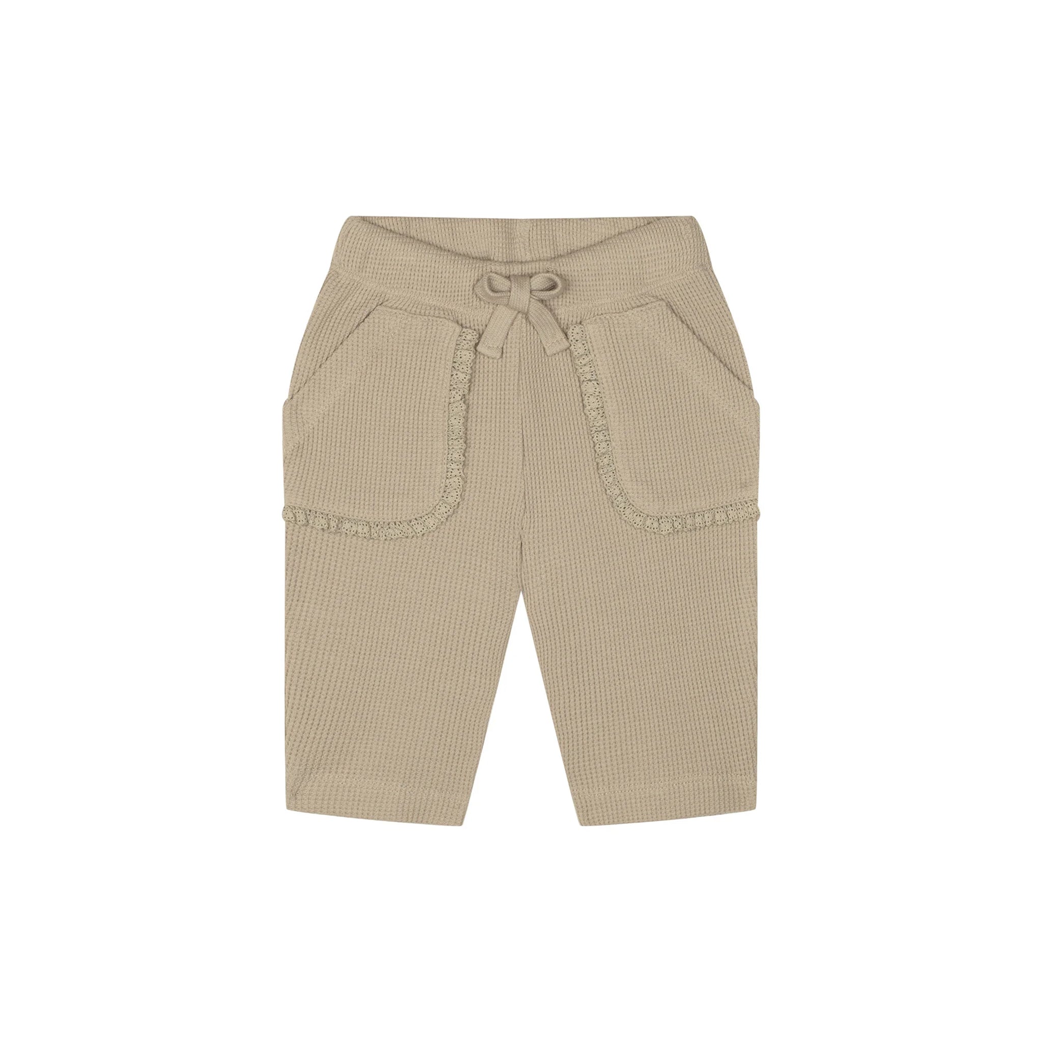 A pair of beige ribbed knit shorts for toddlers, featuring a drawstring waistband, side pockets with decorative ruffle trim, and a relaxed fit, shown against a plain white background.