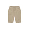 A pair of beige ribbed knit shorts for toddlers, featuring a drawstring waistband, side pockets with decorative ruffle trim, and a relaxed fit, shown against a plain white background.