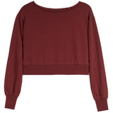 A long-sleeve cropped sweatshirt in a deep burgundy color, featuring a wide boat neckline, ribbed hem, and ribbed cuffs, shown against a plain white background.
