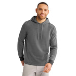 A man wearing a dark heather gray pullover hoodie with white drawstrings, black ribbed cuffs photographed against a solid white background.