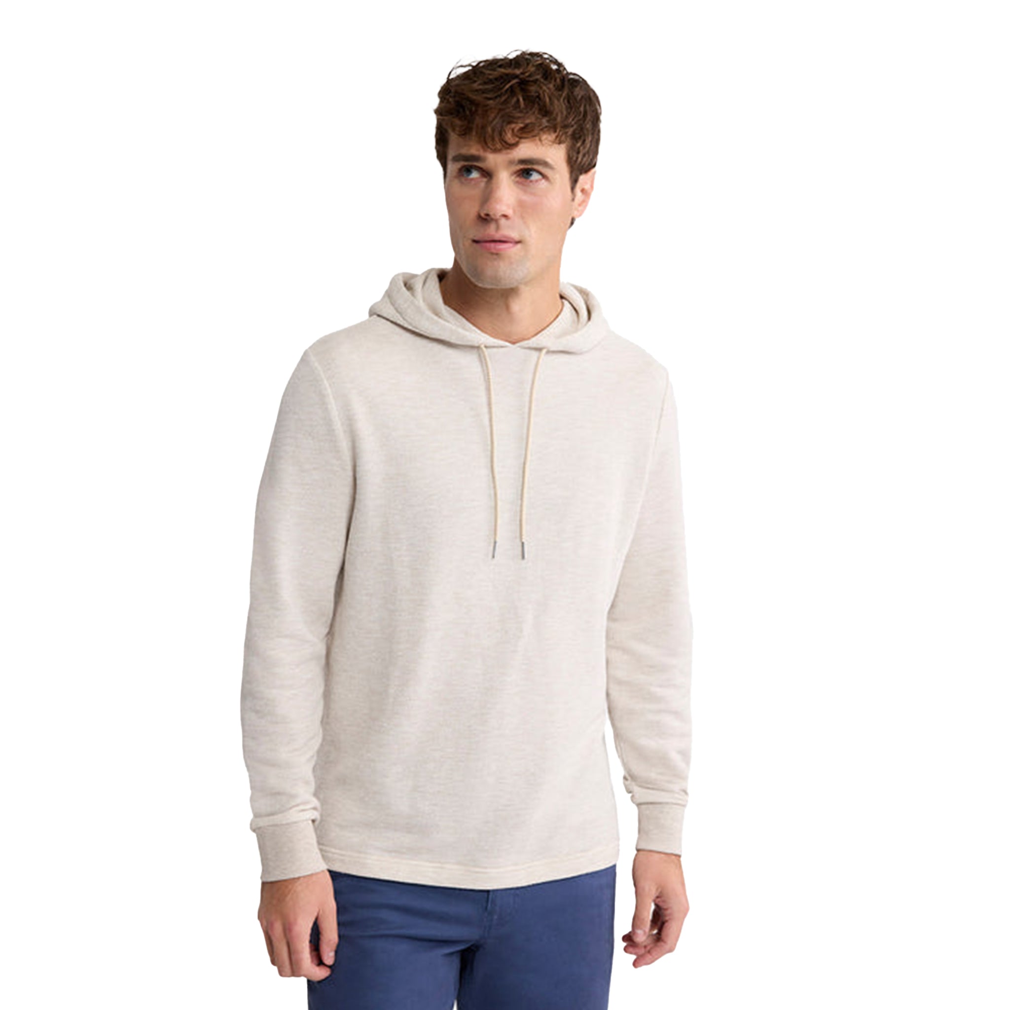 A man wearing a light beige heathered pullover hoodie with drawstrings standing against a solid white background.