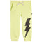 Light yellow-green jogger pants with a large black lightning bolt graphic on the right leg, featuring a white drawstring with black bolts.