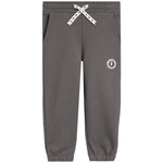 A pair of dark gray sweatpants with a white braided drawstring and a small white circular logo on the left thigh, shown against a plain white background.