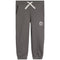 A pair of dark gray sweatpants with a white braided drawstring and a small white circular logo on the left thigh, shown against a plain white background.