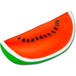 A watermelon slice-shaped squishy featuring a bright red-orange center with black seeds and a green and white rind, isolated on a white background.
