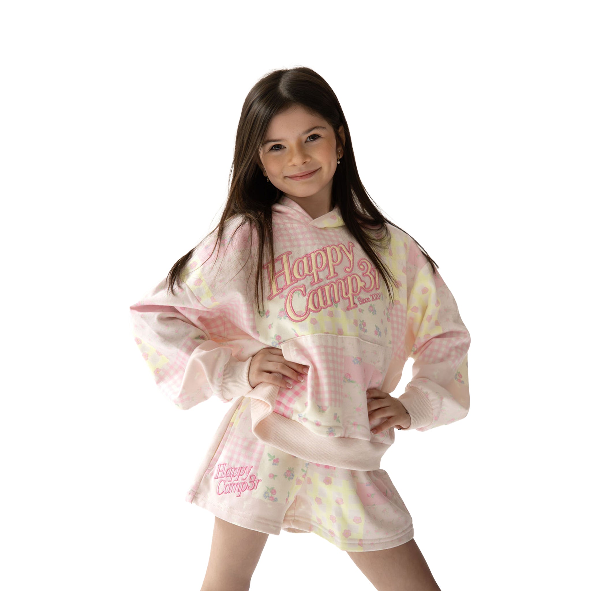 Child wearing a 'Happy Campers' multi-patterned light pink shorts and hoodie on a white background