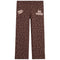 Brown pants with a beige floral pattern, featuring 'Happy Camp3r' on the left thigh and 'BE KIND!' on the right thigh, shown flat on a white background.