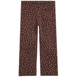 A pair of dark brown pants featuring a small, repeating beige abstract floral pattern, shown flat against a solid white background.