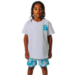Child wearing a white t-shirt with a blue letter 'B' with a blue gummy bear and blue patterned shorts on a white background