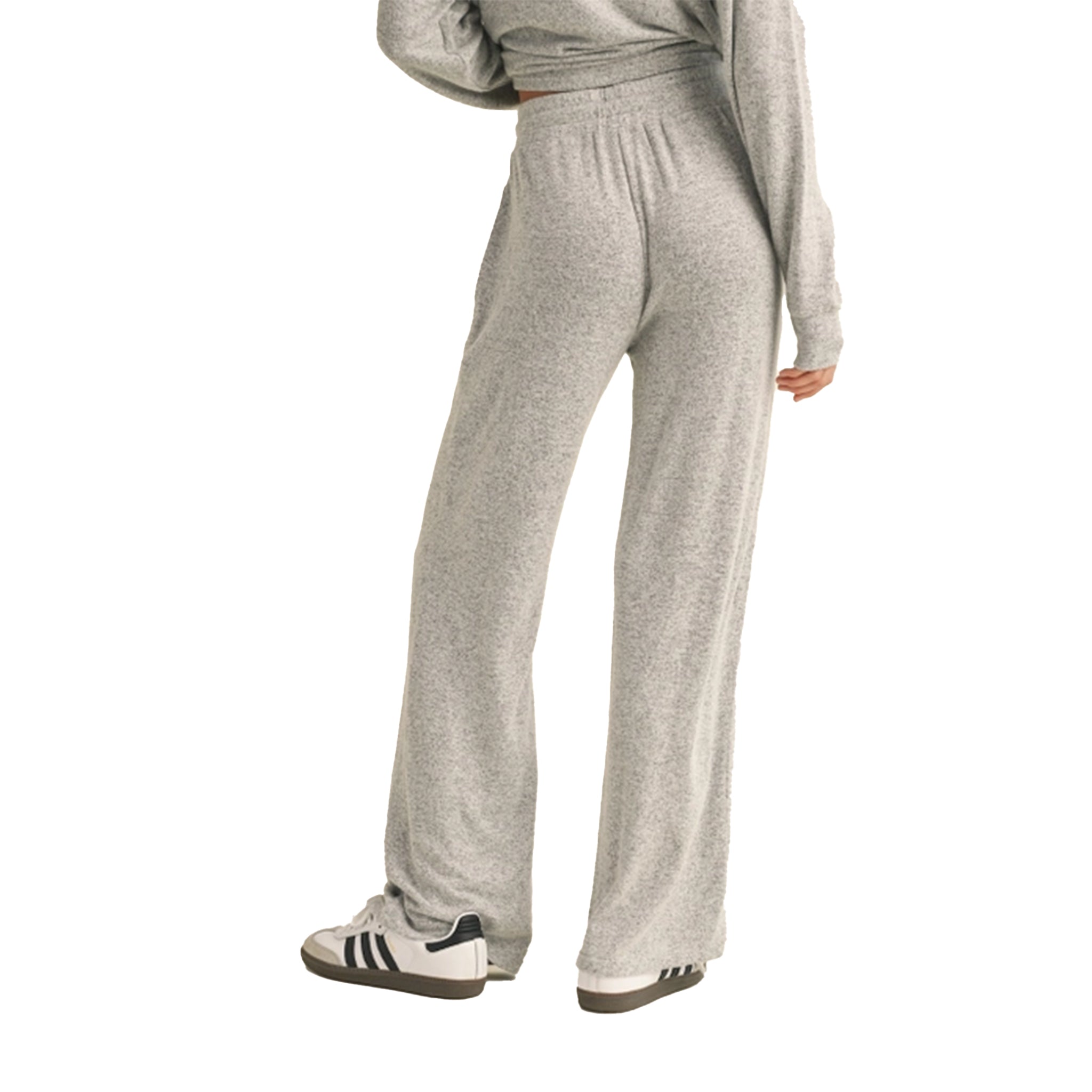 A person wearing light heather gray wide-leg sweatpants and a matching long-sleeve top, shown from the back against a plain white background.