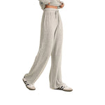 A person wearing light heather gray drawstring sweatpants with a matching cropped sweatshirt and white sneakers, shown against a plain white background.