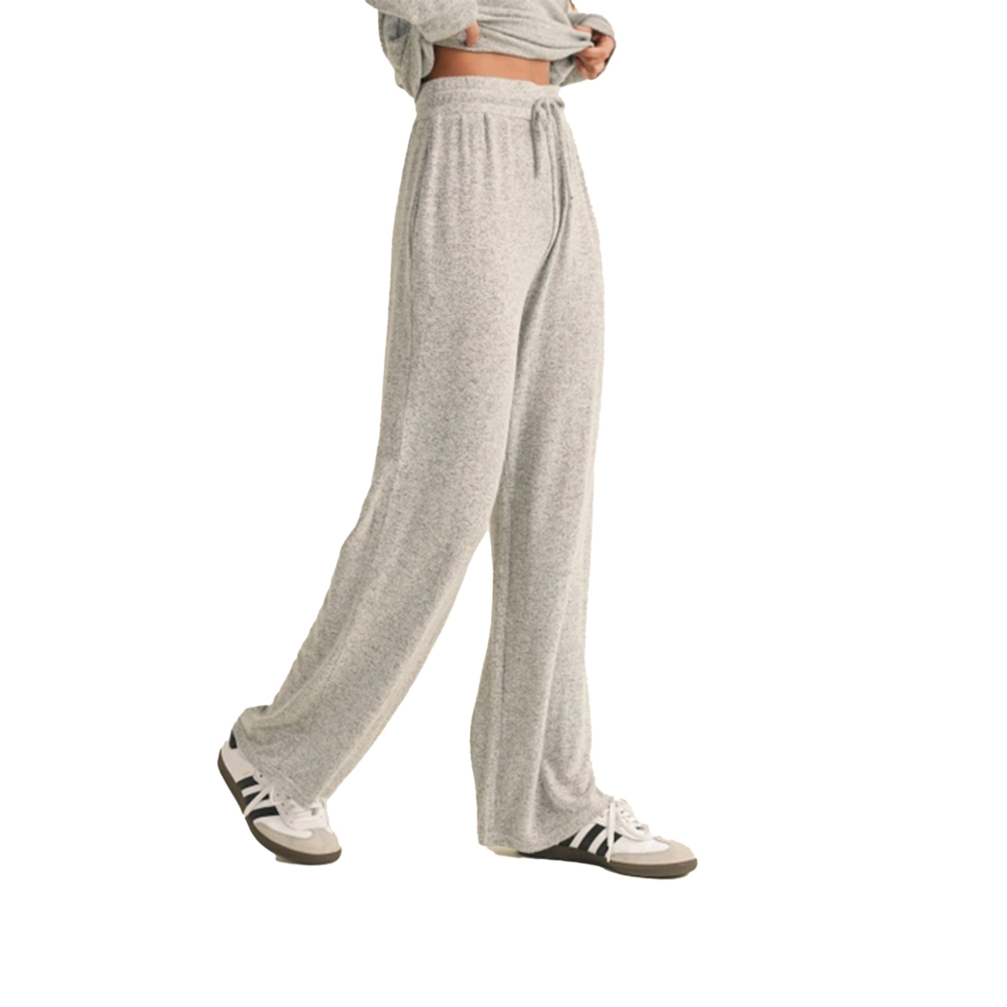 A person wearing light heather gray drawstring sweatpants with a matching cropped sweatshirt and white sneakers, shown against a plain white background.