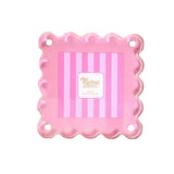 A pink scalloped-edge square photo frame with four mounting holes, on a white background.