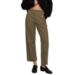 A person wearing olive green cropped pants with a black cropped top and black loafers, shown from the chest down on a plain white studio background.