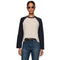 A woman modeling a long-sleeve raglan baseball tee with a light beige body and dark navy sleeves against a plain white background.