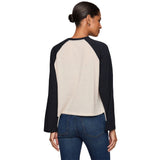 A woman shown from the back wearing a long-sleeve raglan baseball-style top with a cream body against a plain white background.