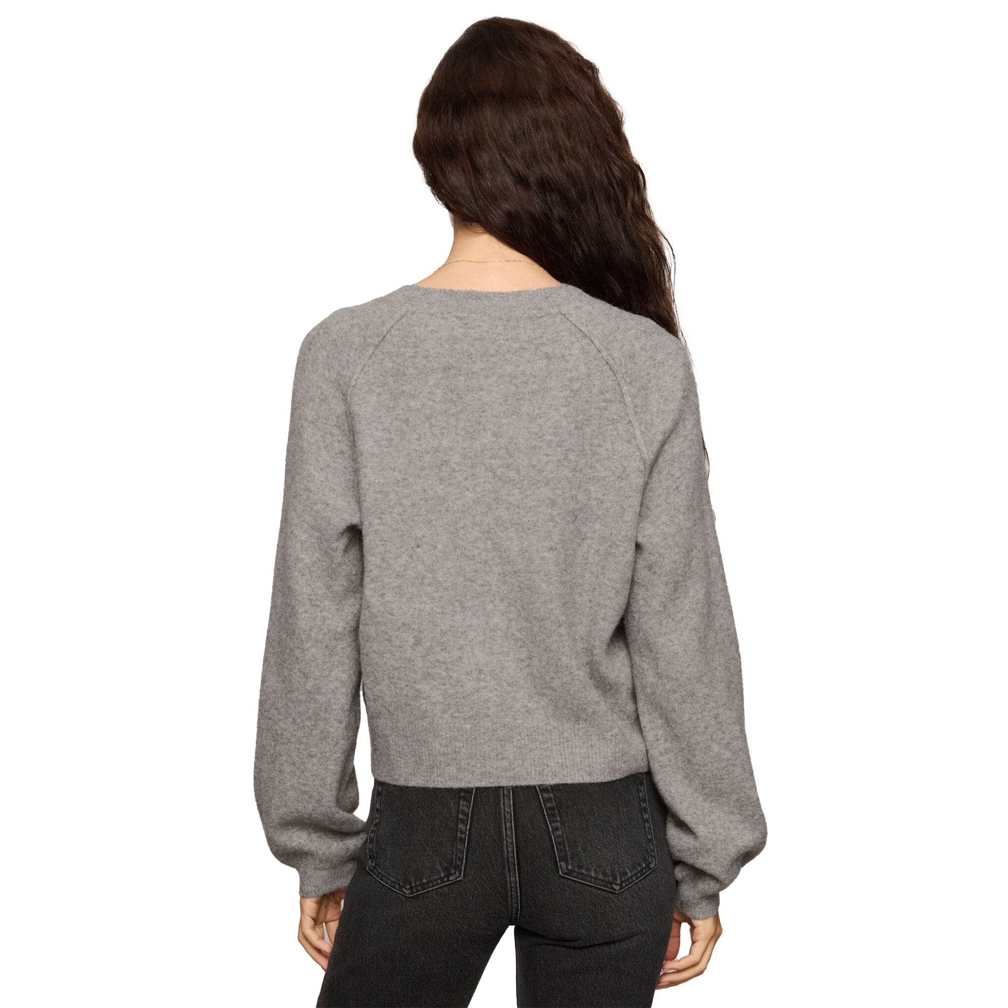 A woman viewed from the back wearing a heather gray cropped crewneck sweatshirt and dark gray jeans against a plain white background.
