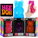 NeeDoh Gummy Bear toys in different translucent colors (pink, purple, orange) shown alongside a large blue bear and a hand squeezing a pink bear,